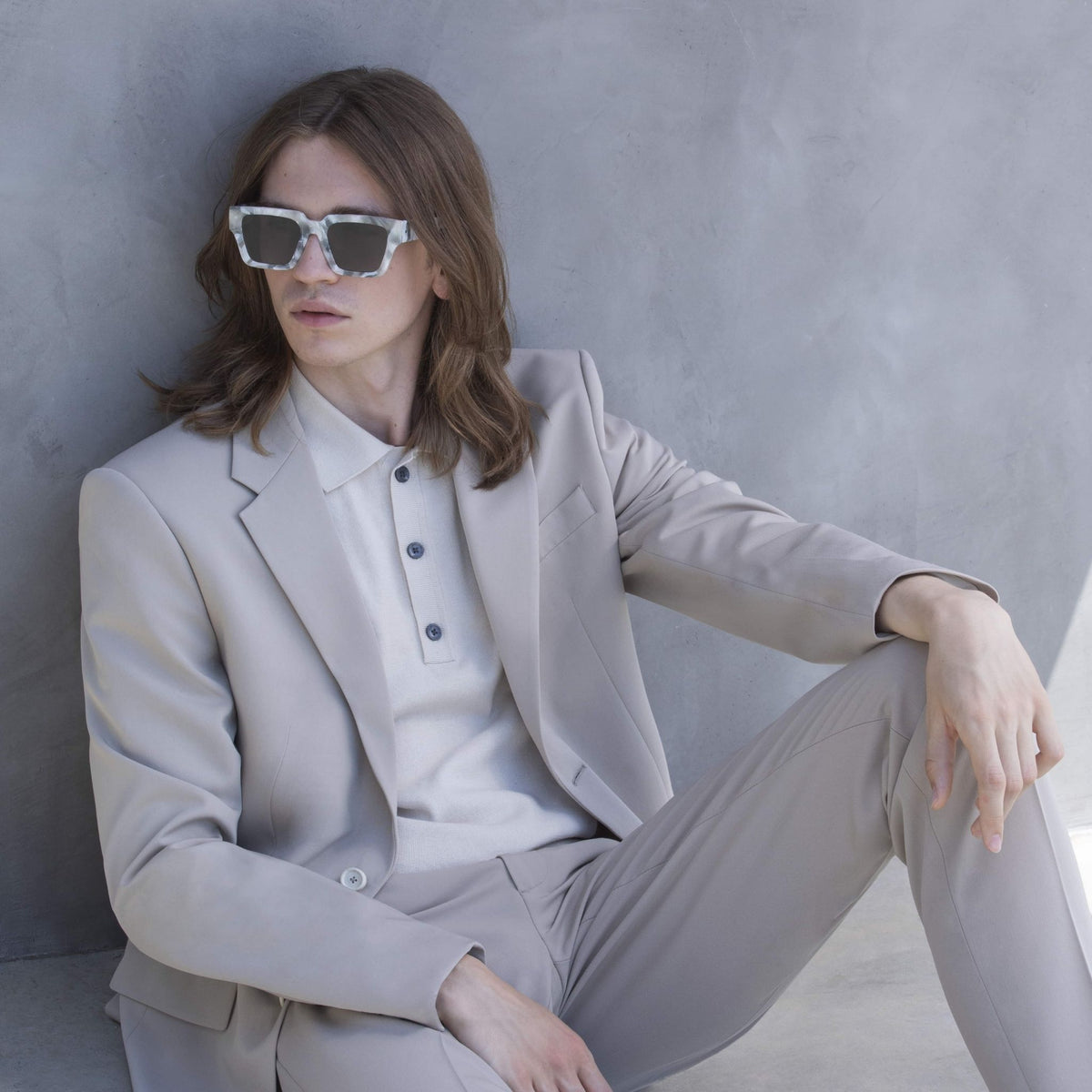 a woman wearing sunglasses sitting on a toilet