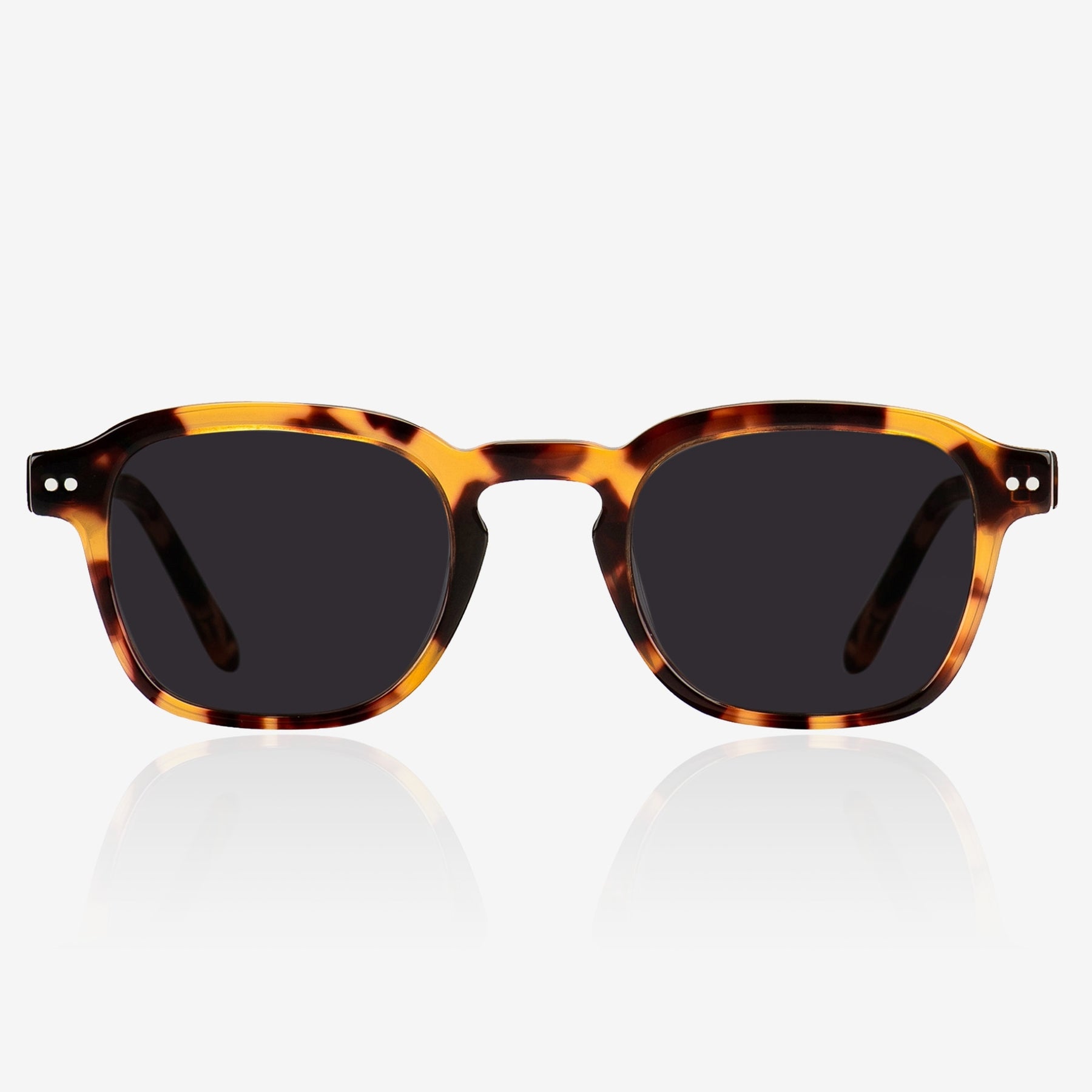 a pair of glasses sitting on a white surface 